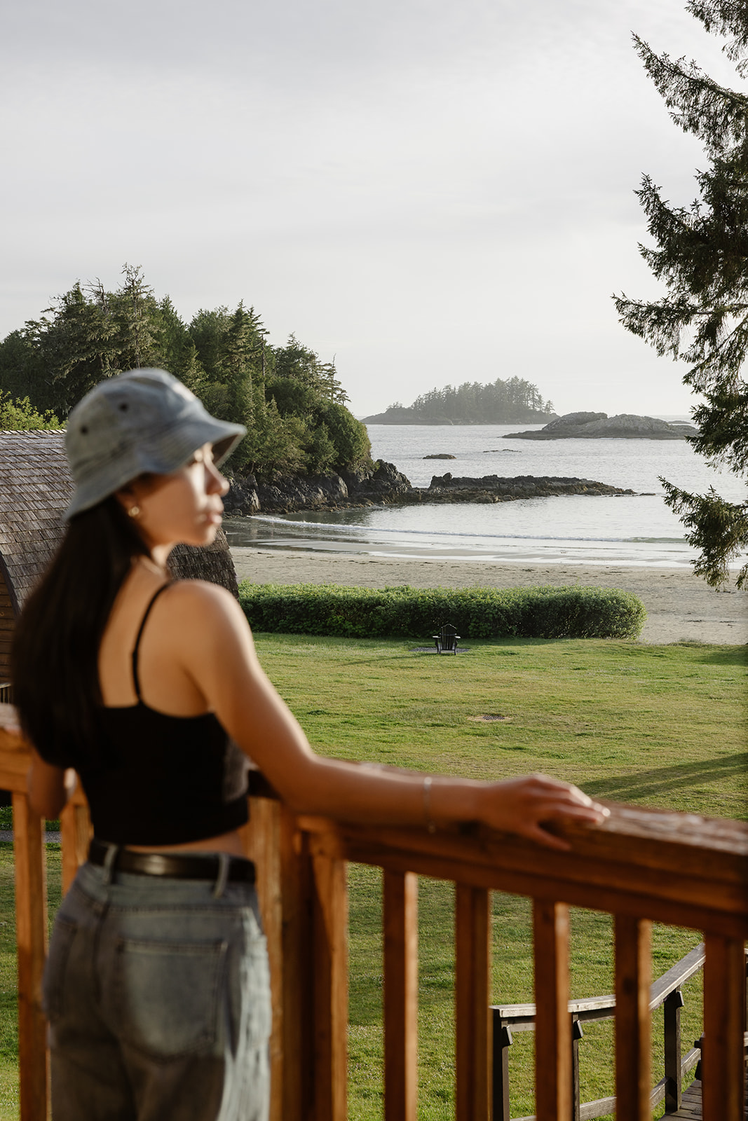 girl gazing toward the ocean from cabin balcony