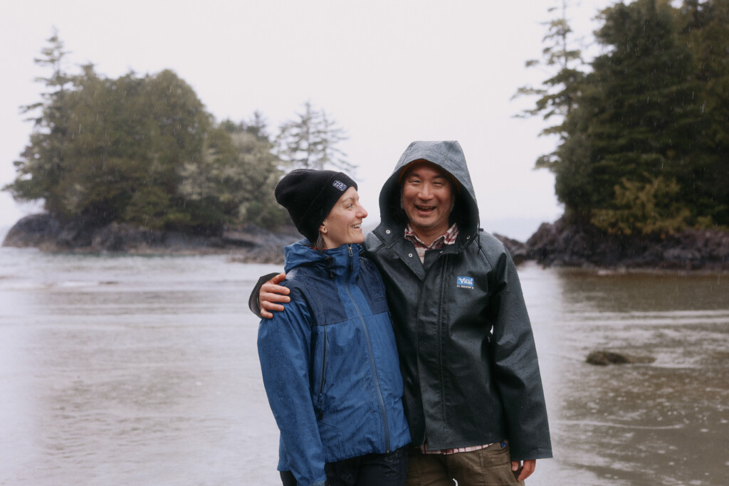 Couple on a Tofino beach in raincoats